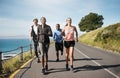 We know the benefits of regular exercise. a group of people out running together.