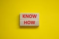 Know how symbol. Wooden blocks with words `Know how` on beautiful yellow background, copy space. Business, innovation and know h