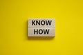 Know how symbol. Wooden blocks with words `Know how` on beautiful yellow background, copy space. Business, innovation and know h