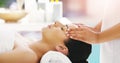 We know how to rejuvenate your body and mind. a young woman getting a head massage at a spa.