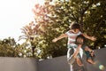 We know just how to have the most fun. a father giving his little son a piggyback ride outdoors. Royalty Free Stock Photo