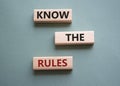 Know the rules symbol. Wooden blocks with words Know the rules. Beautiful grey green background. Business and Know the rules Royalty Free Stock Photo