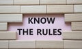 Know the rules symbol. Wooden blocks with words Know the rules. Beautiful pink background. Business and Know the rules concept. Royalty Free Stock Photo