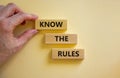 Know the rules symbol. Wooden blocks with words `know the rules` on beautiful white background. Businessman hand. Business, know Royalty Free Stock Photo