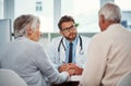 They know theyre in good hands with him. a doctor having a consultation with a senior couple in a clinic. Royalty Free Stock Photo