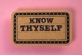 Know Thyself. Cardboard sticker with text on a pink background Royalty Free Stock Photo