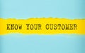 KNOW YOUR CUSTOMER text on the torn paper , yellow background Royalty Free Stock Photo