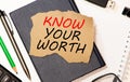 Know Your Worth appearing behind ripped brown paper Royalty Free Stock Photo