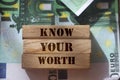 Know Your Worth on wooden blocks pur on 100 Euro banknotes. High salary big wages high qualification concept Royalty Free Stock Photo