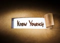 Know yourself appearing behind torn paper Royalty Free Stock Photo