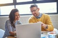 Knowing your client base is key to success. coworkers working together on a laptop in an office.