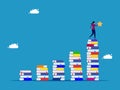 knowledge achievement or a successful sequence of learning steps. woman holding a star on a pile of books growing up Royalty Free Stock Photo