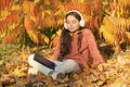 Knowledge assimilate better this way. Small girl enjoy learning online in autumn environment. Little child listening to Royalty Free Stock Photo