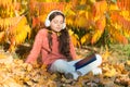 Knowledge assimilate better this way. Small girl enjoy learning online in autumn environment. Little child listening to Royalty Free Stock Photo