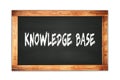 KNOWLEDGE BASE text written on wooden frame school blackboard