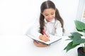 Knowledge concept. School girl write at lesson, knowledge. Knowledge day. If knowledge you need you must read Royalty Free Stock Photo