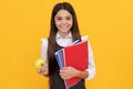 Knowledge is delicious. Happy schoolchild hold apple and books. Knowledge day
