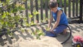 Using a pump, a curious child modeled a volcano eruption in a sandbox