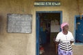 Knowledge is the key for life sign and teacher in front of school house near Tsavo National Park, Kenya, Africa