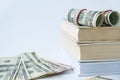 Knowledge leads to wealth. Stack of books with dollars. Concept of expensive education. Money in books. Saving money for Royalty Free Stock Photo