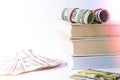 Knowledge leads to wealth. Stack of books with dollars. Concept of expensive education. Money in books. Saving money for Royalty Free Stock Photo