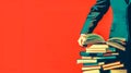 Knowledge power: man with stack of books on red background Royalty Free Stock Photo