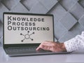 Knowledge Process Outsourcing KPO concept. Man uses laptop.