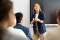 Competent female tutor teaching students in college classroom Royalty Free Stock Photo