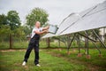 Knowledgeable worker cleaning solar PV batteries. Royalty Free Stock Photo