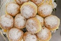 Known in Brazil as a dream, it is a kind of sweet bread filled with cream and covered with sugar that is being placed on top of th