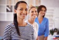 She knows her team always has her back. Three confident young businesswomen smiling at the camera.