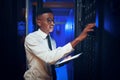 He knows his way around big data. a young man using a digital tablet while working in a server room. Royalty Free Stock Photo