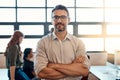 He knows how to get a team to get results. Portrait of a confident mature businessman standing in a modern office with