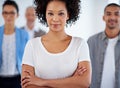 She knows how to reach the necessary goals. Beautiful young businesswoman with coworkers in the background.