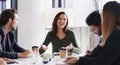 She knows how to simplify success for her team. a group of businesspeople having a meeting in a boardroom.