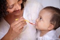 She knows its my favourite flavour. A cute baby girl being fed by her mother. Royalty Free Stock Photo