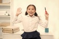 She knows right answer. Child girl wears school uniform standing excited face expression. Schoolgirl smart child looks