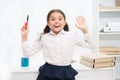 She knows right answer. Child girl wears school uniform standing excited face expression. Schoolgirl smart child looks