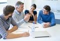 He knows whats best for business. a group of businesspeople discussing work during a boardroom meeting.