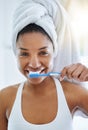 She knows whats best for her teeth. Portrait of an attractive young woman brushing her teeth in the bathroom at home.