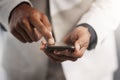 He always knows whats happening. Closeup shot of an unrecognizable businessman using a cellphone.