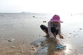 Ko Phangan, Thailand, March 15, 2022: octogenarian woman seek clams on the sea