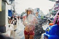 KO SAMUI, THAILAND - APRIL 13: Unidentified girl shooting water at the camera in a water fight festival or Songkran Festival