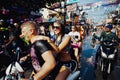 KO SAMUI, THAILAND - APRIL 13: Unidentified wet happy tourists on a bike on Songkran Festival