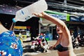 KO SAMUI, THAILAND - APRIL 13: Unidentified woman pouring ice water by the collar on Songkran Festival