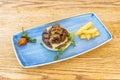 Kobe beef burger with stewed onion, arugula leaves, mushrooms, fundido cheese and homemade fries Royalty Free Stock Photo