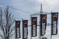 Koblenz, Germany - April 22, 2021: flags with the logo and lettering of the Saturn media retailer in front of a high voltage pylon