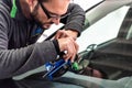 Koblenz Gerrmany 04.04.2018 man using repairing equipment to fix damaged cracked windshield at wintec company