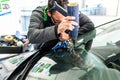 Koblenz Gerrmany 04.04.2018 man using repairing equipment to fix damaged cracked windshield at wintec company