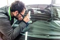 Koblenz Gerrmany 04.04.2018 man using repairing equipment to fix damaged cracked windshield at wintec company